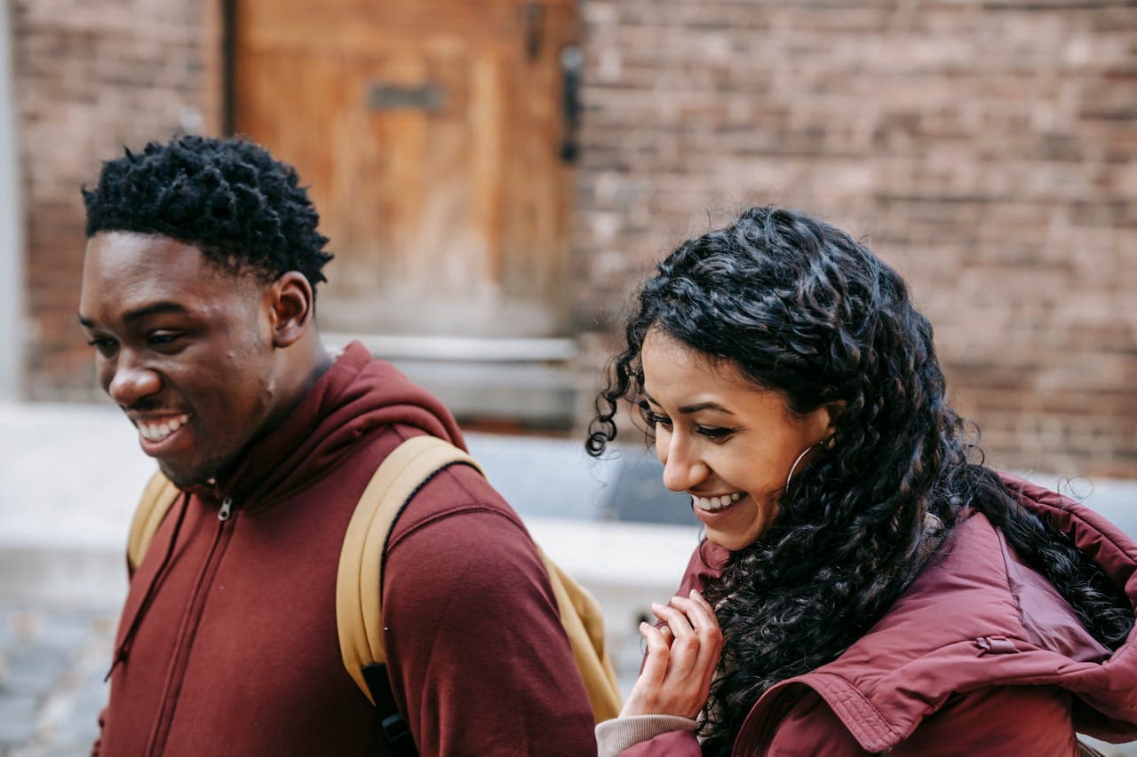 Young man woman laughing holding phone